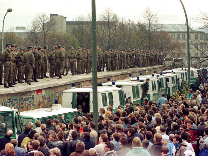 Looking out onto a sea of thousands, East Berlin border guards stood atop the Berlin Wall at the Brandenburg Gate on November 11.