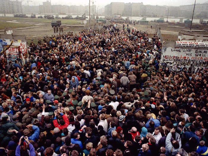 East Berliners cross and meet West Berliners at Potsdamer Platz after the Berlin Wall was torn down at this checkpoint on November 12. Over 2 million people from East Berlin visited West Berlin just that weekend.