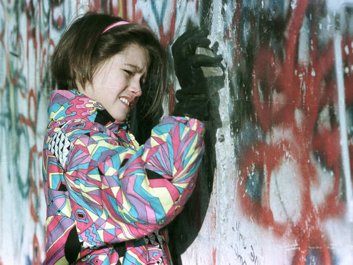 Even days later, citizens wanted to participate in the destruction — here, a young West German girl hammers the Berlin Wall on November 19.