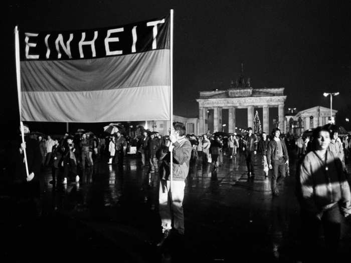 This flag, reading "Unity," was waved high as these Germans crossed the newly opened border on December 22.