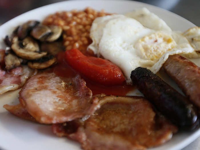 ENGLAND: The fortifying English breakfast includes eggs, sausage, bacon, beans, mushrooms, and cooked tomato.