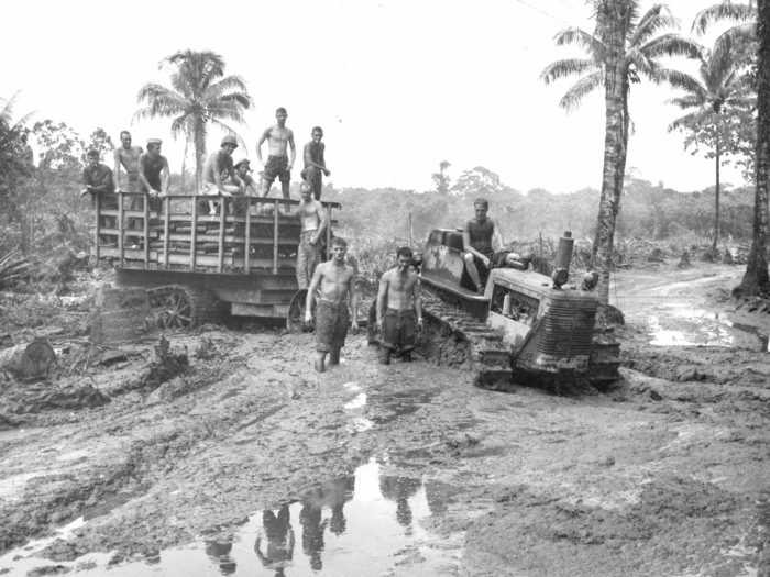 Surrounded by a sea of mud, Marines stationed in the South Pacific island of Bougainville haul ammunition to the front line.