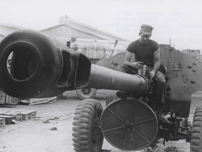 A Marine dismantles a 122mm Vietnamese field piece that was captured during battle in 1969.