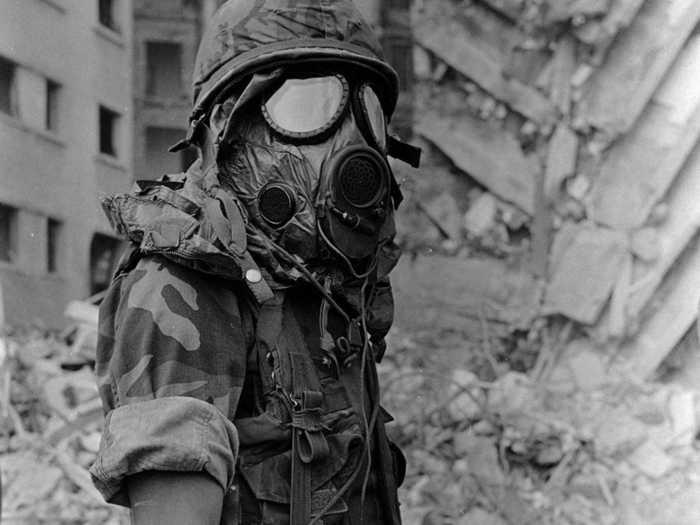 In 1983 the US Embassy in Beirut was bombed by Islamic terrorists. It was the deadliest attack on a US diplomatic mission up to that time. This photo shows a Marine wearing a gas mask while digging through the rubble to find survivors.