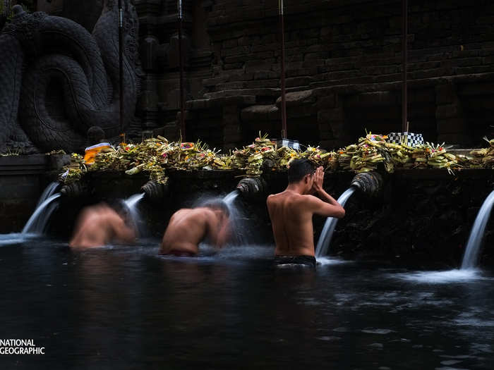 Men take part in a bathing ritual in the Tirta Empul Temple in Bali. The temple