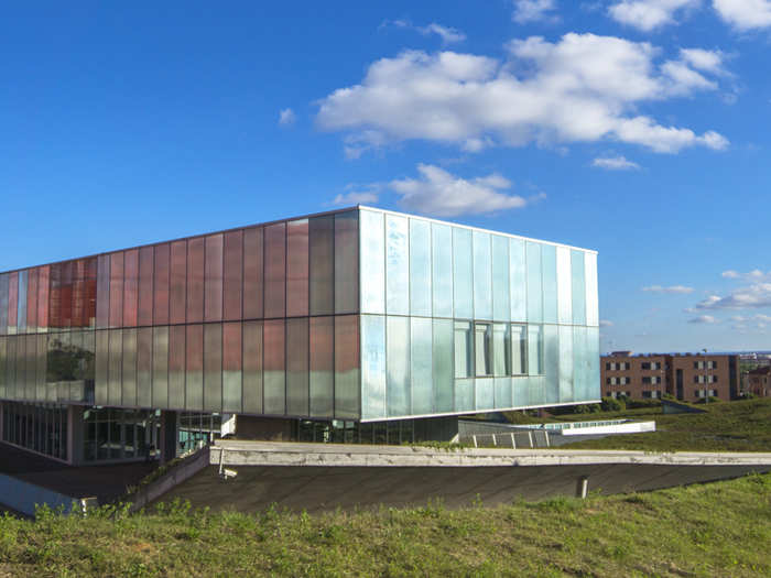 The Institute of Neurosciences of Castilla y León, located in Salamanca, cuts into its sloping site and replaces the original landscape with a new one. The vegetated roof is punctuated with four skylights and two light wells, and skirted in a generous deck.