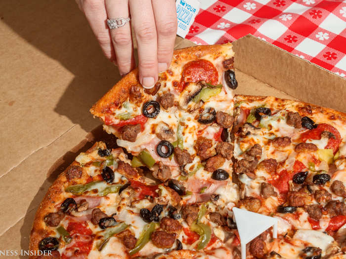 The crust, while thick, barely holds up to this mound of toppings. It does the job, but ...