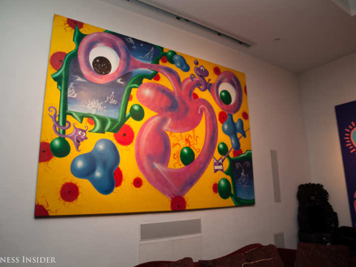 Opposite the bed is "Moonray Man," by Kenny Scharf.