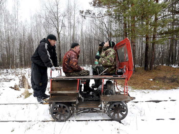 A few rely on rail pushcars; a man nicknamed "Barcelona," Alexey Bolotov and Alexey Jakushin often drink vodka as they travel to Kalach by motorized pushcar.