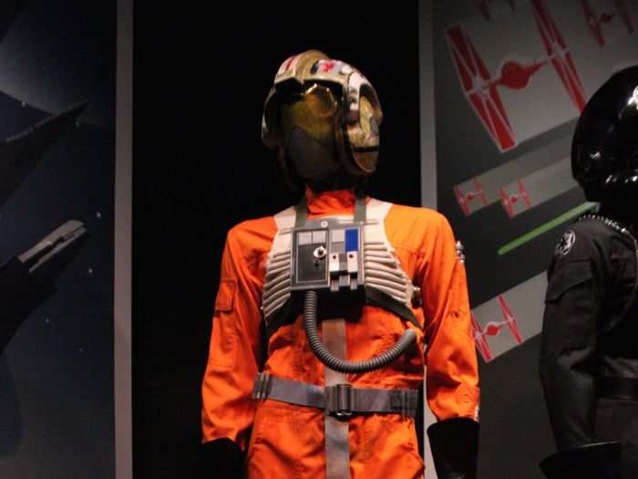 The X-Wing pilot costume was inspired by Mercury 7 astronauts, some of whom wore orange jumpsuits.