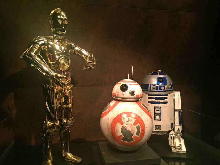 The original C-3P0 and R2-D2 costumes worn by Anthony Daniels and Kenny Baker are joined by the new, smaller droid BB-8.