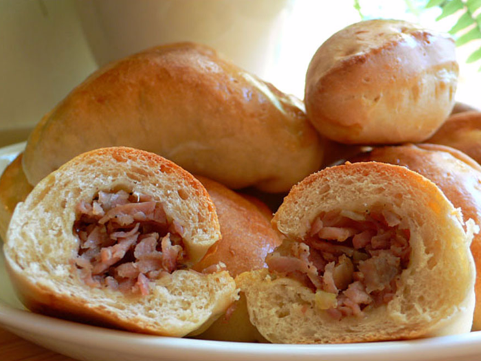 LATVIA: While you won’t necessarily find an abundance of street carts serving food in Latvia, one of the most common snacks to pick up and eat as you walk are piragi — buns that are filled with chopped onion and bacon and commonly found in bakeries.