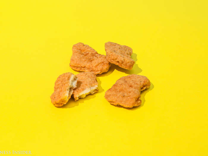 On first bite, we taste a little kick — possibly thanks to the noticeable pepper flakes in the breading. But these nuggets have a spongy texture that feels very questionable.