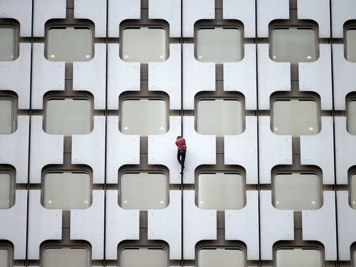 Alain Robert, who is known as "The French Spiderman," climbs Paris