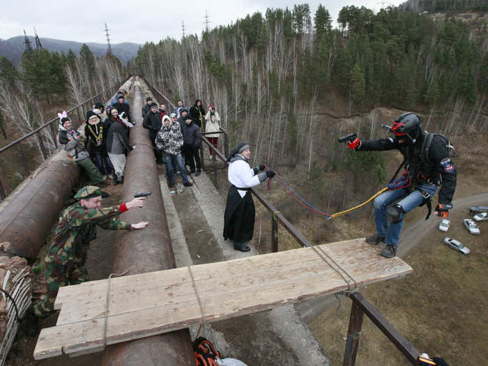 A rope-jumper braces to leap from a 144-foot bridge in Russia.