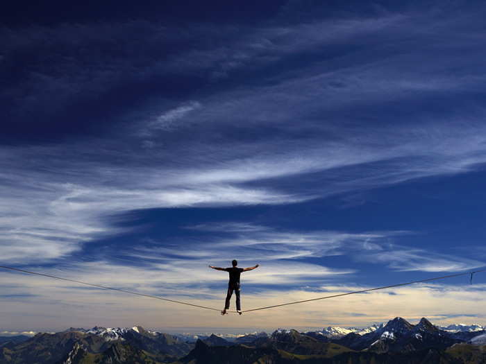 A competitor in the Highline Extreme event walks over a thin wire high above the mountains of Switzerland. The lines of wire range anywhere from 148 feet to 1,624 feet long.