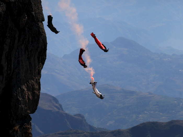 Wingsuit flyers take air in the Yunnan province of China as they practice for a competition.