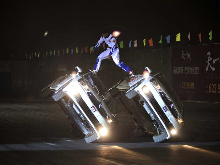 During the course of a drift game in the Shanxi province of China, stunt drivers jump from car to car while the vehicles are turned on their sides.