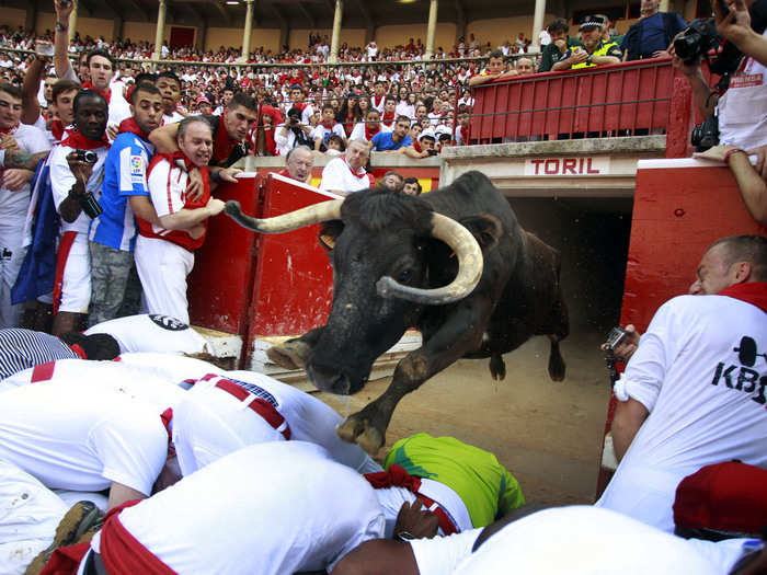 The running of the bulls takes place at the annual San Fermin festival in Pamplona, Spain. Bulls charge behind runners during an event that usually takes three to four minutes.