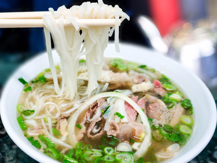 In Vietnam, slurp up a bowl of steaming hot pho, a tangy beef noodle soup.