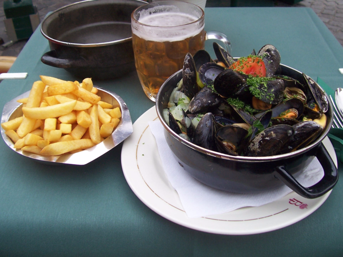 Dig into a steaming bowl of moules frites in Belgium.