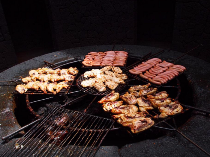 Experience a one-of-a-kind BBQ dish at El Diablo Restaurant in Lanzarote, Spain, where heat from an active volcano is used to cook the food.