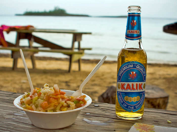 While in the Bahamas, cool off with a bowl of fresh conch salad and a cold Kalik beer while listening to the waves and burying your feet in the sand.