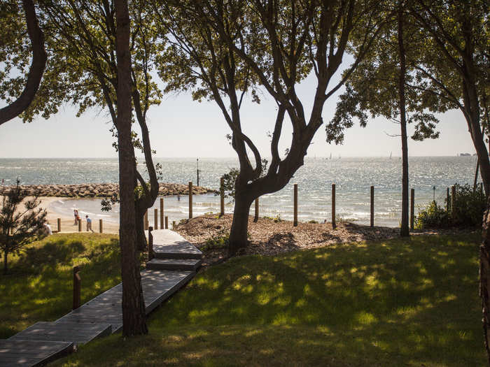 The back of the house includes a grassy area and a path down to the beach, which is shared with other Sandbanks residents.