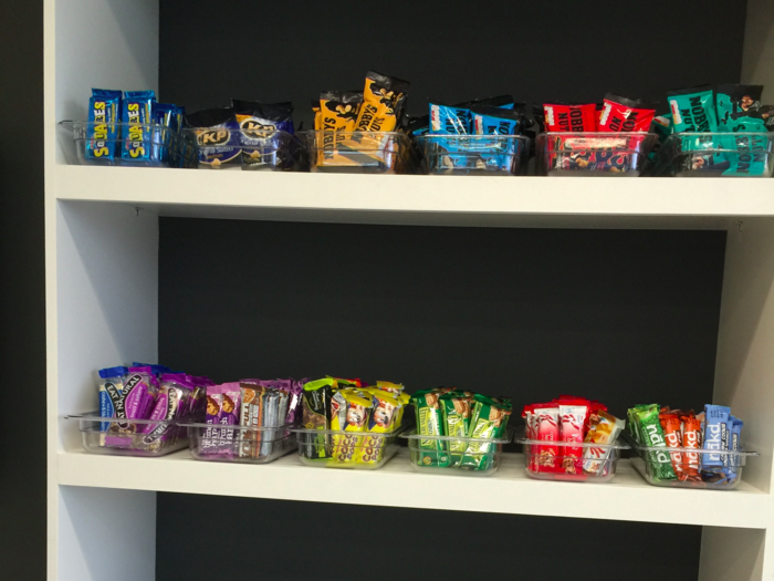 Snacks are provided free of charge and arranged on a several tiered shelf in the kitchen.