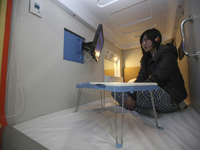 A "capsule hotel" in China, within the city of Qingdao, packs an LCD TV into each of its 2-by-1 meter spaces.