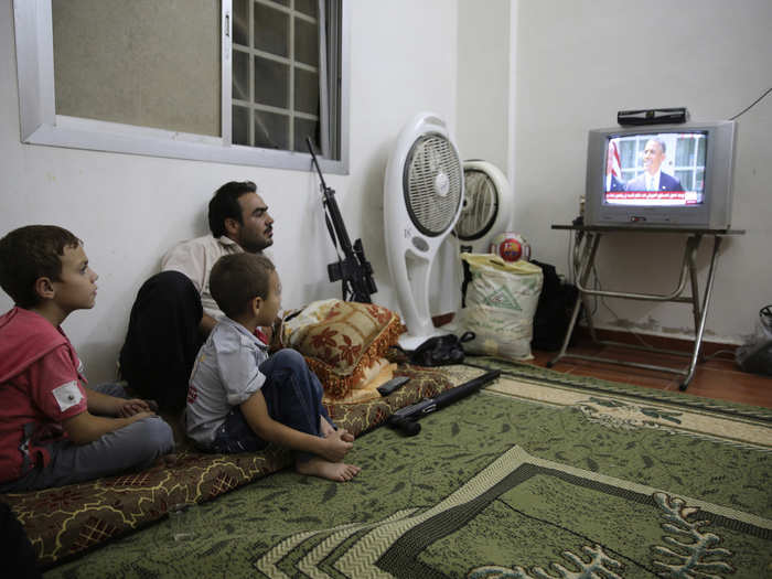 A Free Syrian Army fighter watches a speech by Barack Obama from Ghouta, Syria.