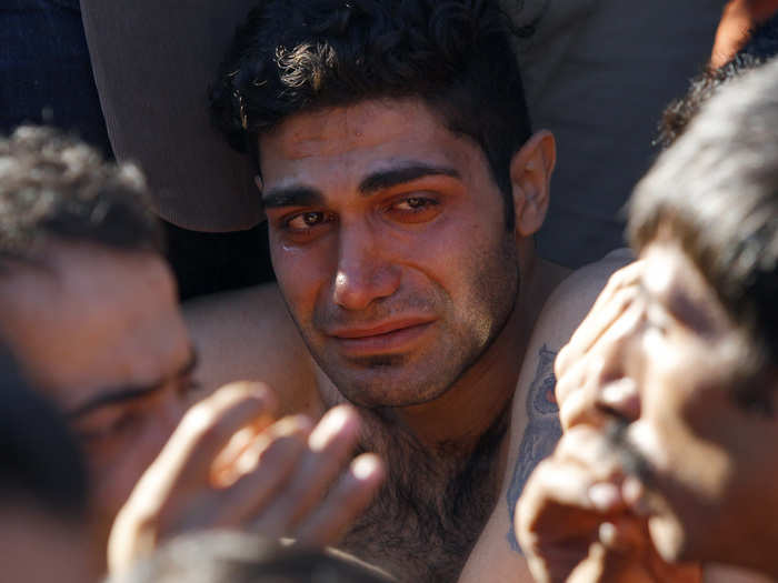 A migrant cries as he watches other migrant gets his mouth sewed up during a protest next to the border from Greece to Gevgelija, Macedonia.