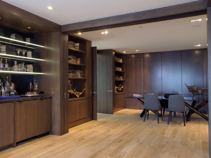 The dining room is lined with rich dark wood.