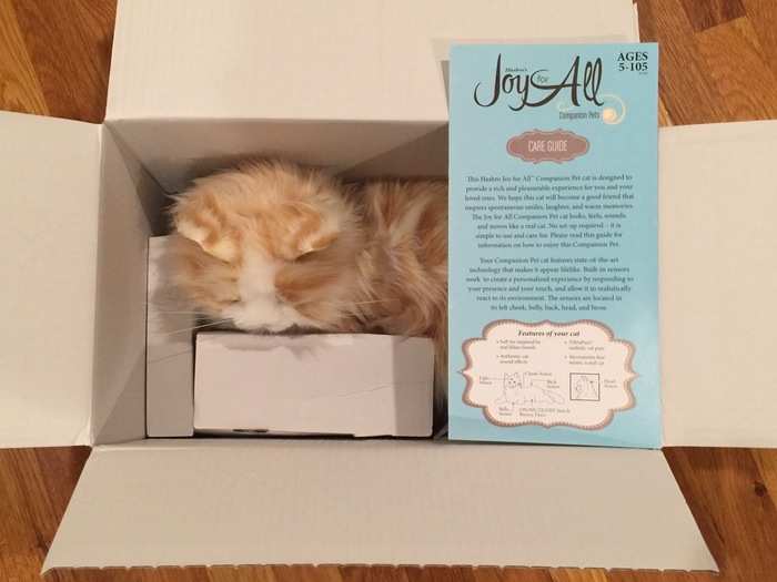 I ripped open the packaging and found my robot cat tucked inside with some information on how he