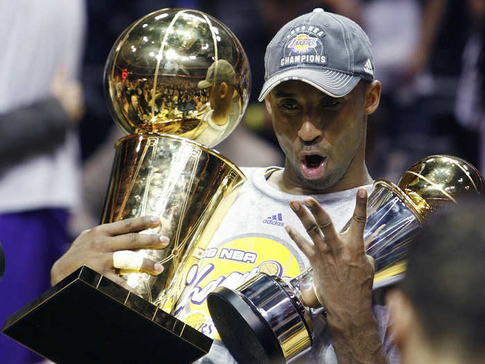 After the Lakers defeated the Orlando Magic to win the NBA championship in 2009, Bryant celebrated by holding up both the Finals MVP Award and the championship trophy.