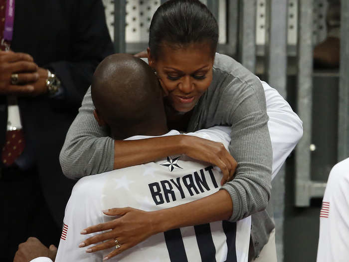 First Lady Michelle Obama hugs Bryant at the end of the men