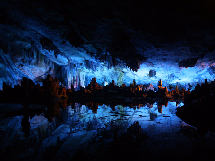 Stretching nearly 800 feet, the Reed Flute Cave, located near Gulin, China, is filled with incredible stalactites, stone pillars, and rock formations that take on a breathtaking look when illuminated with colored lighting.