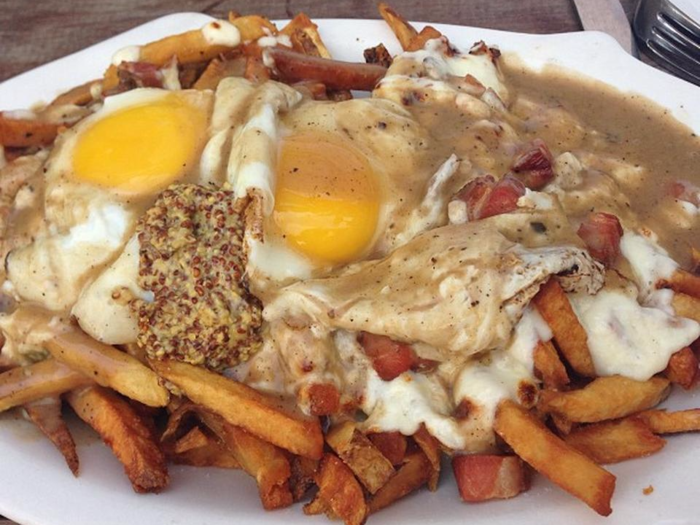 The Greenhouse Tavern in Cleveland makes one-of-a kind "animal style" frites with full slabs of bacon, fried eggs, whole-grain mustard, mozzarella curd, and brown gravy.