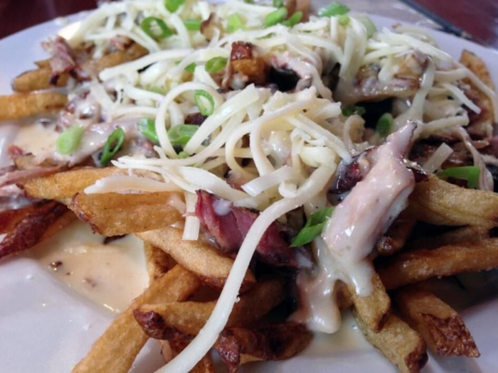 In St. Louis, The Shaved Duck serves up their "smothered fries," topped with pulled rib and pork meat, cheese sauce, and freshly grated sharp cheddar