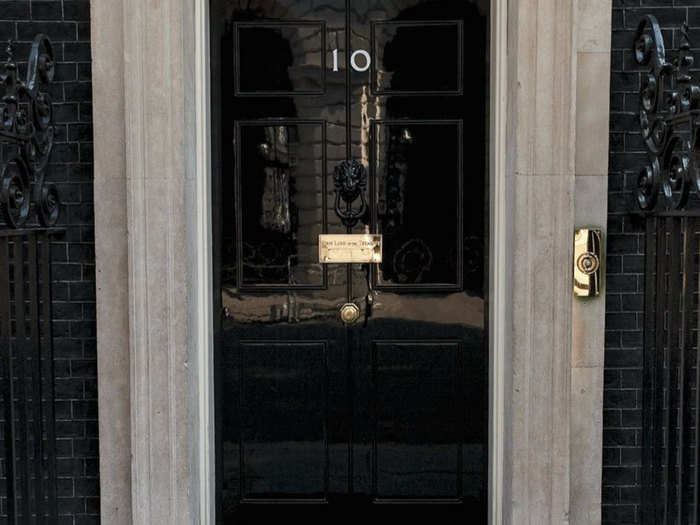 The door features a black iron knocker in the shape of a lion