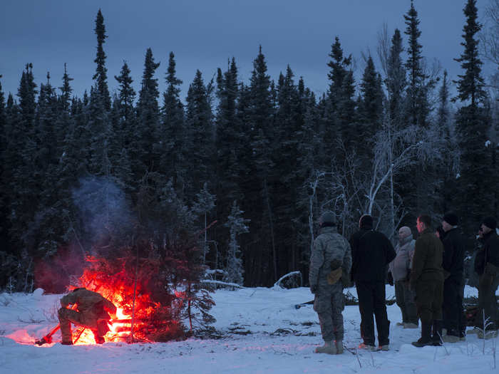 Another vital principal of survival students learn is how to create an effective signal fire by placing a flare inside a base of kindling and smoke-generating tree limbs.