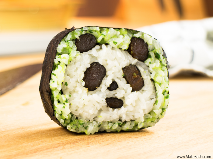 The green rice in this panda sushi roll is made by mixing white rice with coriander. The panda