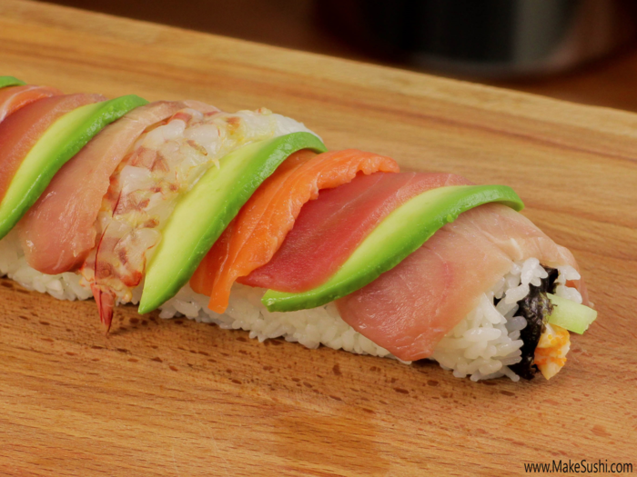 Like a true rainbow roll, this roll is topped with slices of yellowfin tuna, yellowtail, salmon, butterfly shrimp, and avocado. The inside of the roll is filled with a tasty crab mix.