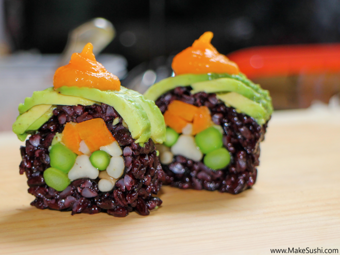 This vegan sushi roll is all about the vegetables: mushrooms, asparagus, avocado, and carrots.