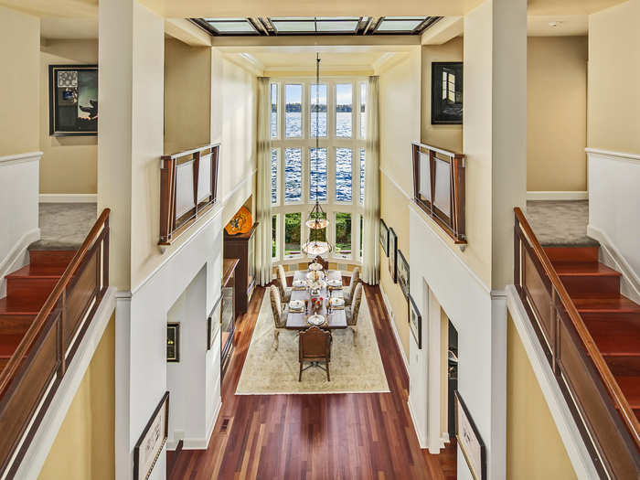 The double staircase is often filled with the music from the piano alcove below. Sunlight beams through the colossal skylight.