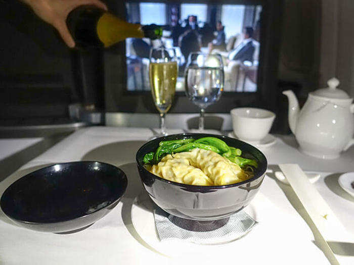 I decided to order a few in flight snacks. No, these are not pretzels and salty crackers you find on US airlines. Cathay pacific offers a variety of hot dishes. I ordered the famous noodle soup with dumplings. While the dumplings were delicious, the soup was a little bit bland even with a healthy dose of Chile paste.