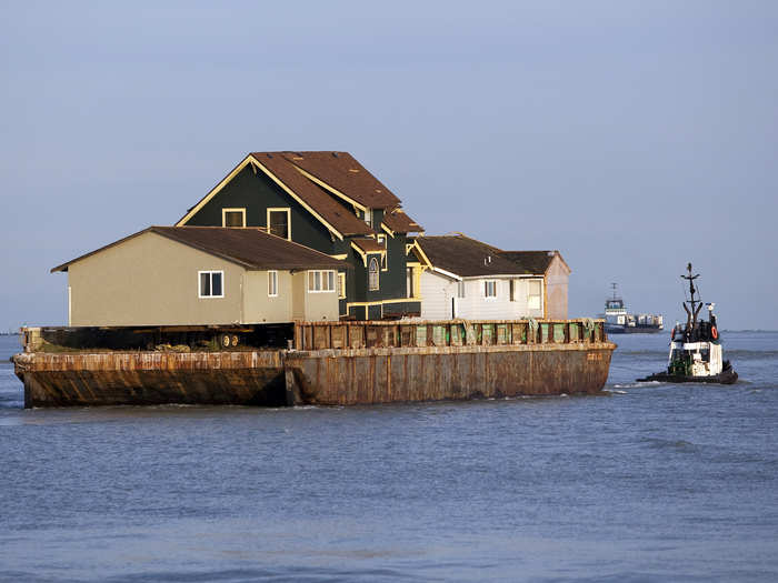 An existing home was removed by barge to make room for a separate activities building.