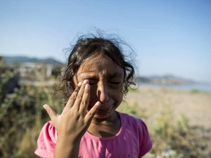 Yasmine, a 6-year-old migrant from Deir Al Zour in war-torn Syria, cries at the beach after arriving on the Greek island of Lesbos September 11, 2015.