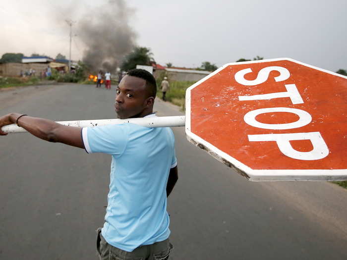 A protester carries a traffic sign during a protest against Burundi President Pierre Nkurunziza and his bid for a third term in Bujumbura, Burundi, on May 26, 2015.