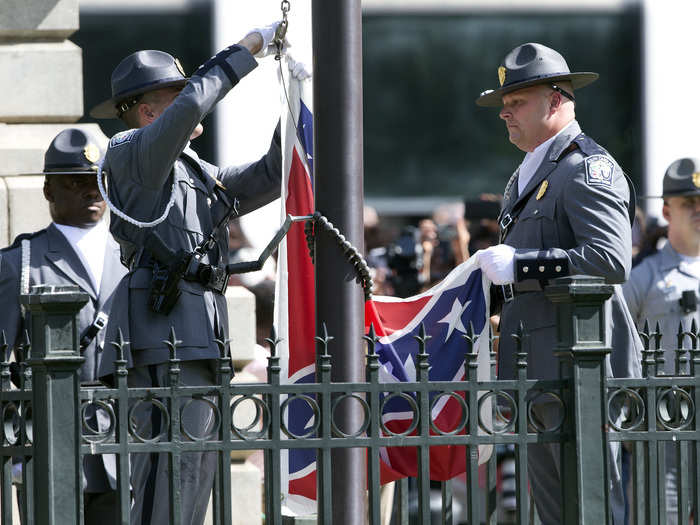 An honor guard from the South Carolina Highway patrol lowers the Confederate battle flag as it is removed from the Capitol grounds on July 10, 2015. The removal of the flag followed a horrific attack on members of the Emanuel African Methodist Episcopal Church on June 17.